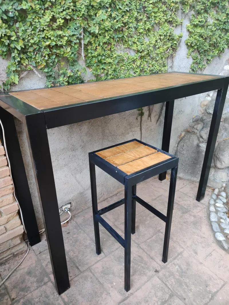 Barra exterior con un banco alto sin respaldo en una terraza